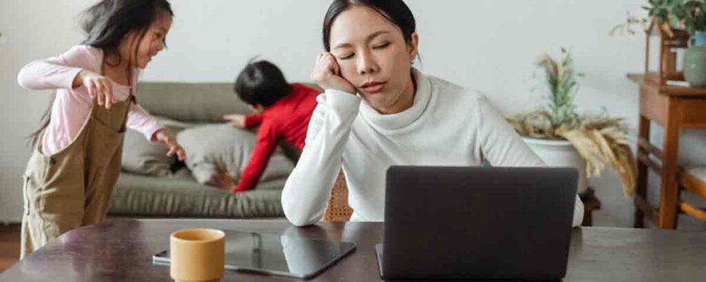 image showing frustrated mother working from home