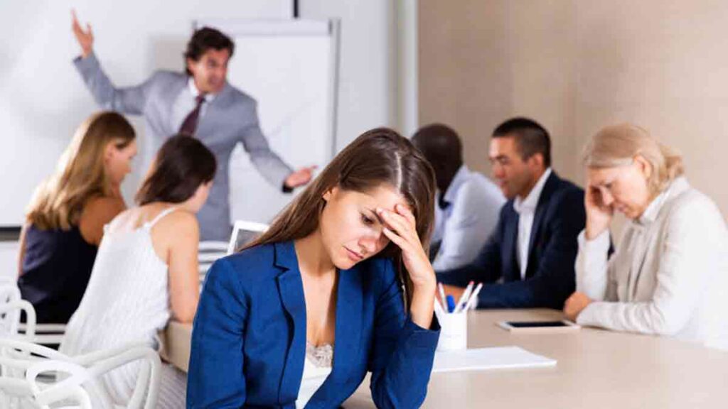 image showing a stressed women and other team members on a meeting